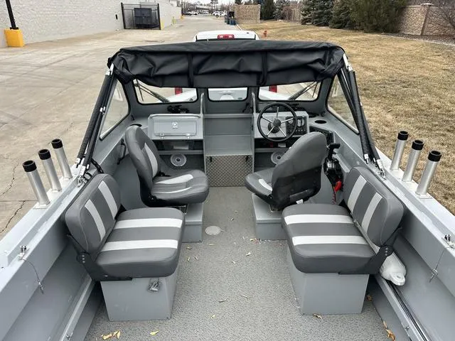 Slide: The Image of 2021 Hewescraft Sportsman 180 SM boat interior with seating and steering wheel. - 6