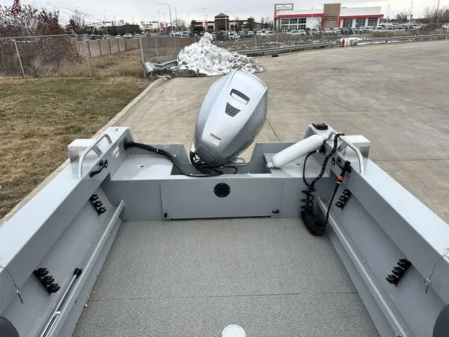 Slide: The Image of 2021 Hewescraft Sportsman 180 SM boat with outboard motor, parked on concrete. - 8