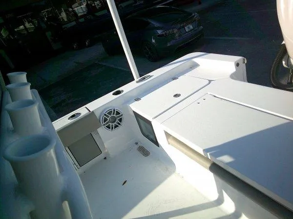 Slide: The Image of 2025 Sportsman 247 MASTERS boat interior with rod holders and storage compartments. - 4