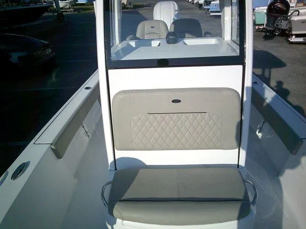 Slide: The Image of 2025 Sportsman 247 MASTERS boat interior with cushioned seating and console. - 6