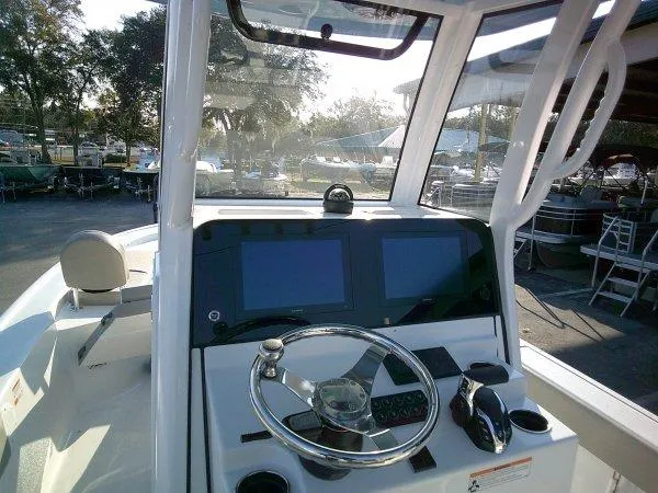 Slide: The Image of 2025 Sportsman 247 MASTERS boat dashboard with dual screens and steering wheel. - 9