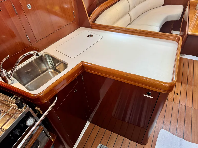 Slide: The Image of Interior of 2006 Beneteau Oceanis Clipper 343 yacht, featuring a sleek kitchen area. - 14