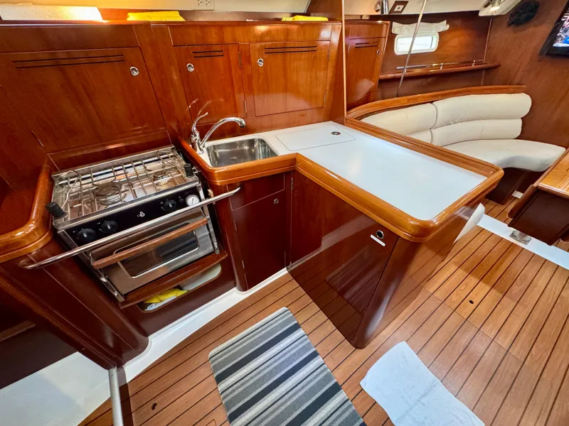Slide: The Image of Interior of 2006 Beneteau Oceanis Clipper 343 yacht with kitchen and seating area. - 15