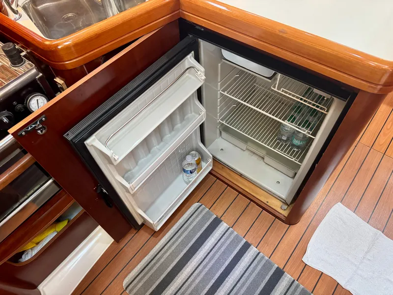 Slide: The Image of Open fridge in 2006 Beneteau Oceanis Clipper 343 yacht galley, showing interior shelves. - 17
