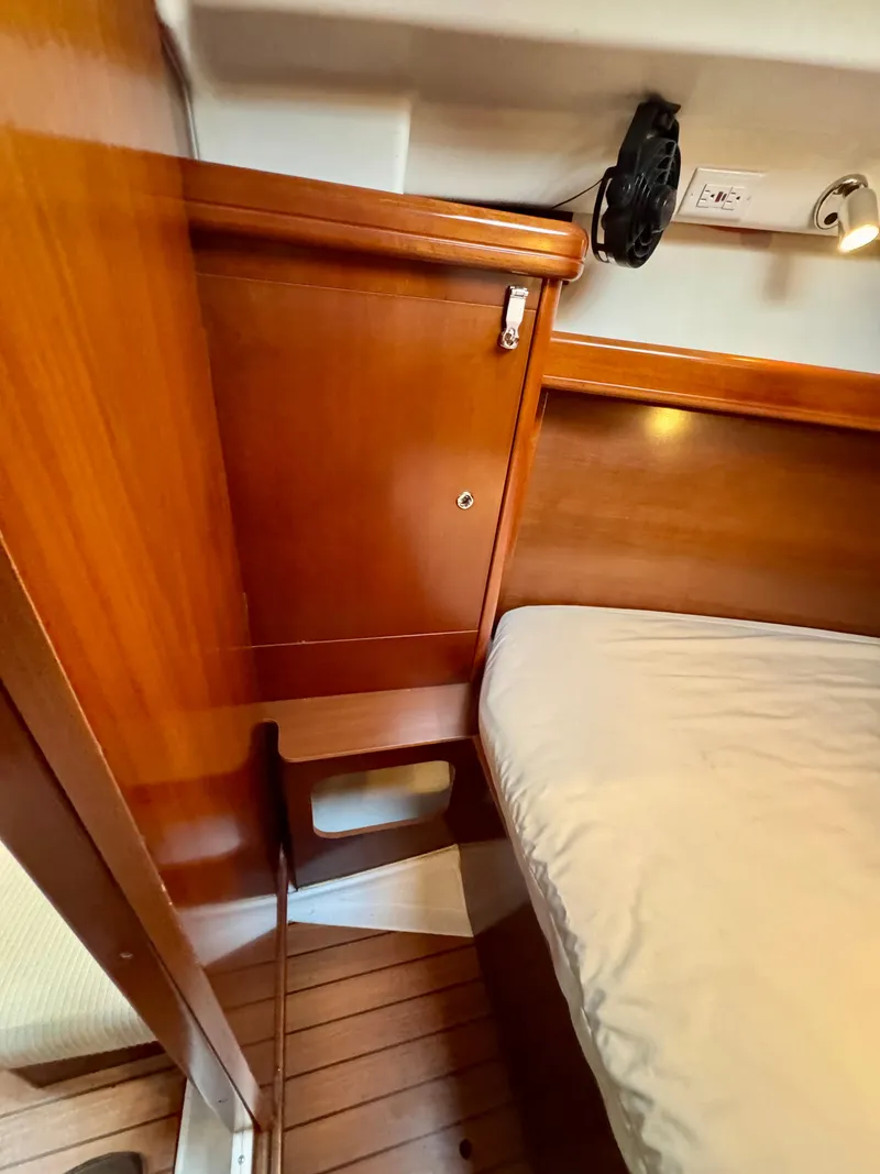 Slide: The Image of 2006 Beneteau Oceanis Clipper 343 cabin interior with wooden finish and bed. - 24