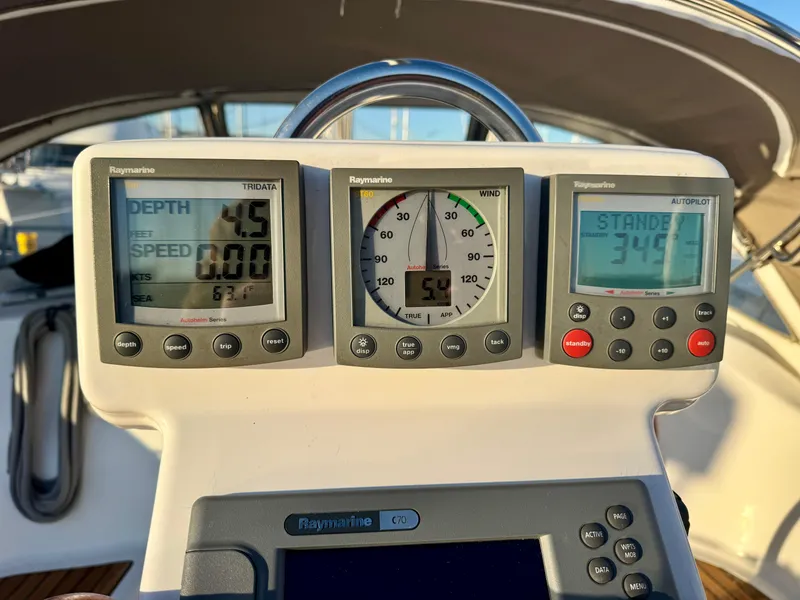 Slide: The Image of Beneteau Oceanis Clipper 343 cockpit instruments, displaying depth, wind, and autopilot settings. - 31