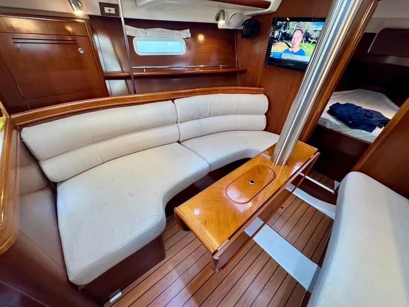 Slide: The Image of Interior of 2006 Beneteau Oceanis Clipper 343 with cozy seating and wooden finishes. - 8