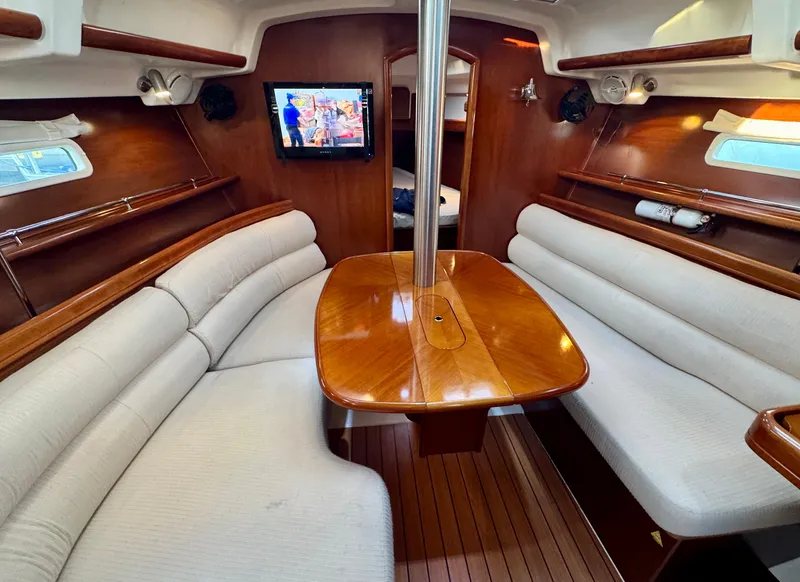 Slide: The Image of Interior of 2006 Beneteau Oceanis Clipper 343 yacht with cozy seating and wooden table. - 9