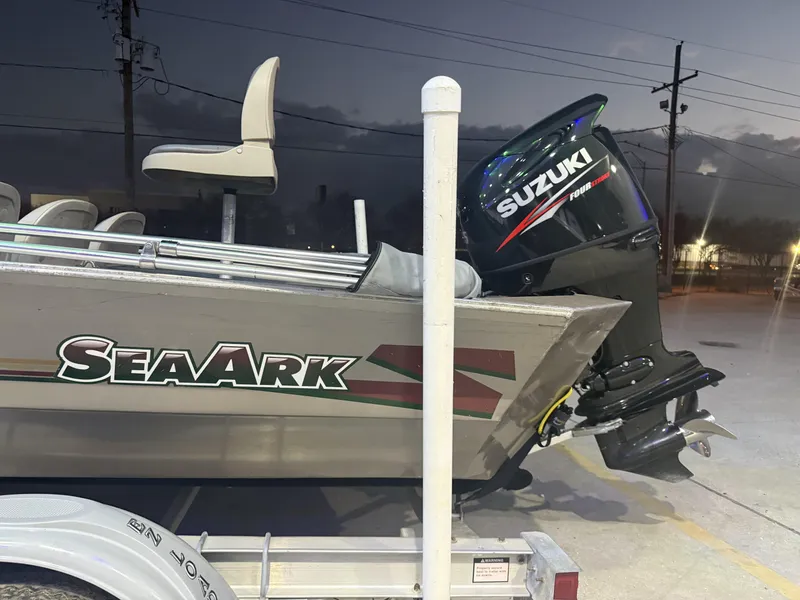 Slide: The Image of 1998 SeaArk ZX180 boat with Suzuki outboard motor at dusk. - 6