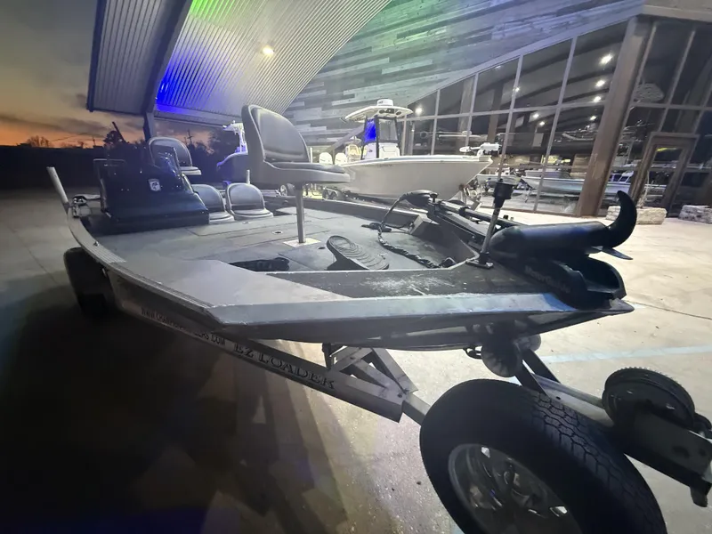 Slide: The Image of 1998 SeaArk ZX180 boat on trailer at sunset, under a modern canopy. - 7