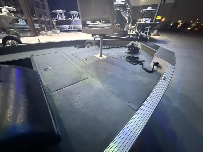 Slide: The Image of 1998 SeaArk ZX180 boat interior with seating and storage compartments. - 9