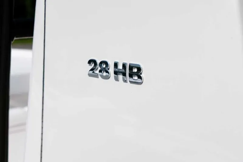 Slide: The Image of Close-up of Caymas 28 HB 2025 emblem on white background. - 19