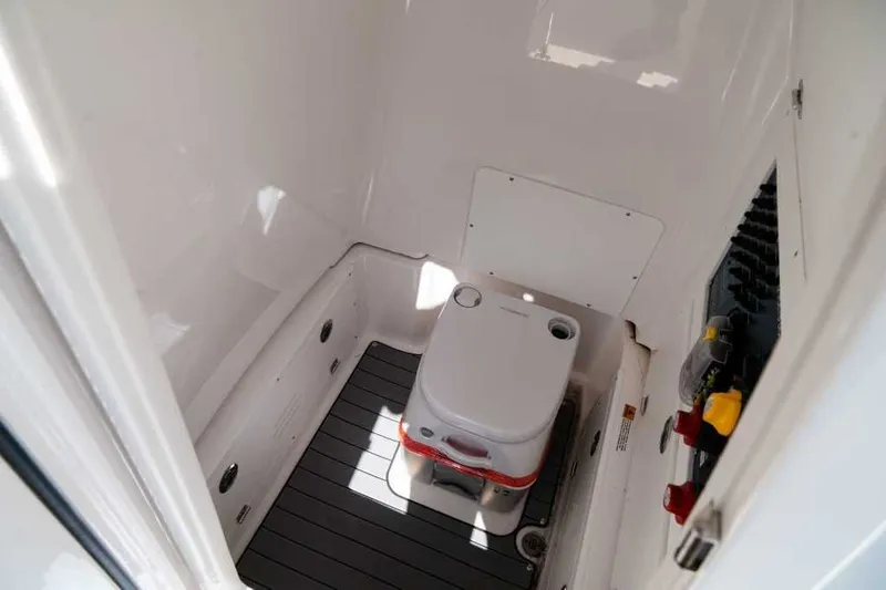 Slide: The Image of Interior of 2025 Caymas 28 HB featuring portable toilet. - 22