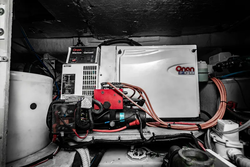 Slide: The Image of 2005 Sea Ray 48 Sundancer cruising on open water under a clear blue sky. - 10