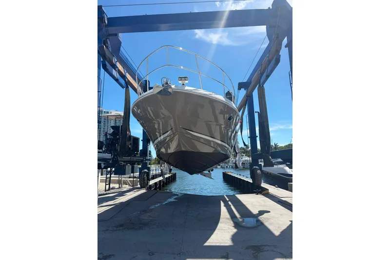 Slide: The Image of 2005 Sea Ray 48 Sundancer yacht in dry dock, suspended by a boat lift. - 56