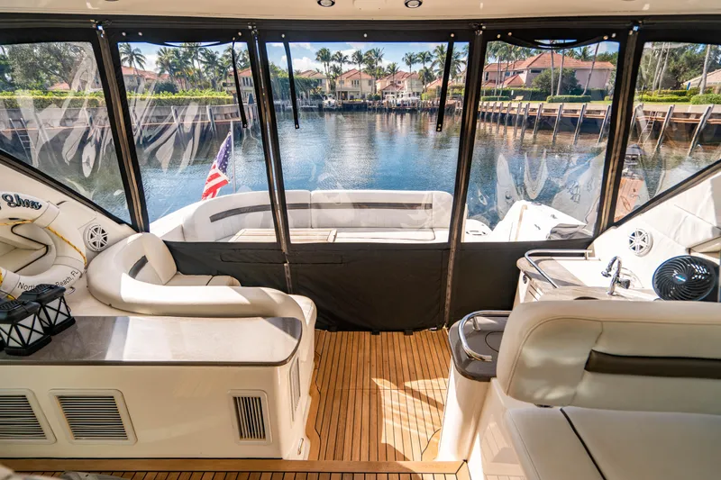 Slide: The Image of Luxurious 2005 Sea Ray 48 Sundancer yacht interior with elegant wood finishes and plush seating. - 20
