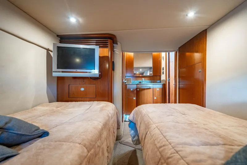 Slide: The Image of Luxurious 2005 Sea Ray 48 Sundancer yacht kitchen with wood cabinetry and modern appliances. - 22