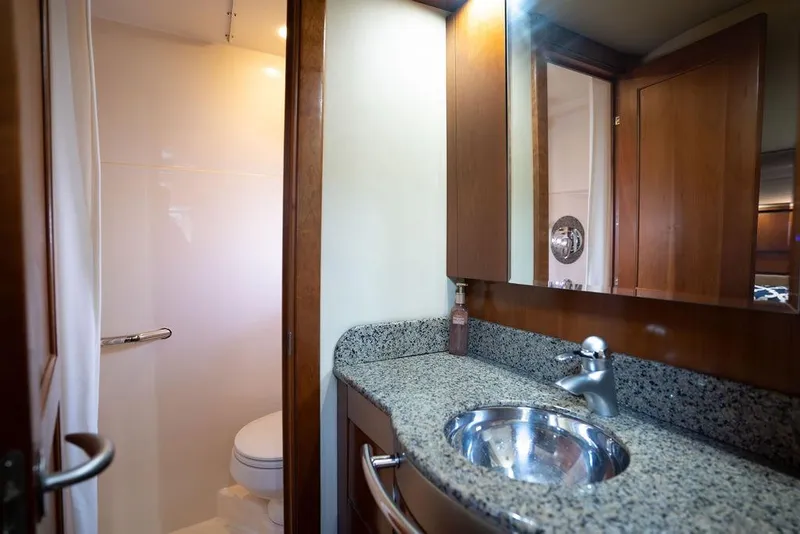 Slide: The Image of Luxurious bathroom in 2005 Sea Ray 48 Sundancer yacht with granite countertop and modern fixtures. - 33