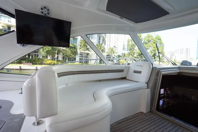 Slide: The Image of Luxurious interior of 2005 Sea Ray 48 Sundancer yacht with white seating and TV. - 36