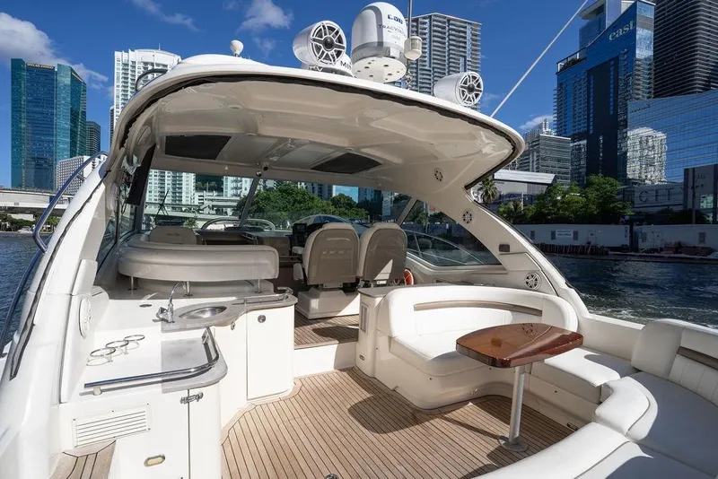 Slide: The Image of 2005 Sea Ray 48 Sundancer yacht with spacious deck, city skyline in background. - 37