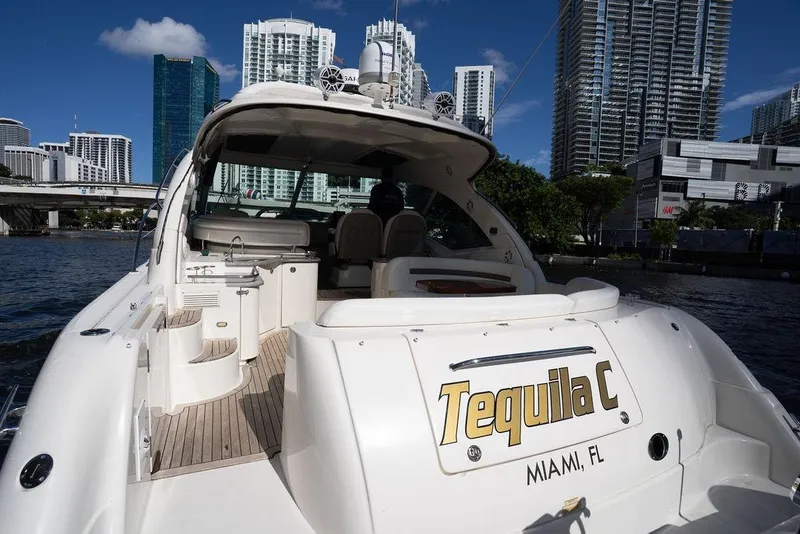 Slide: The Image of 2005 Sea Ray 48 Sundancer yacht docked in Miami with city skyline backdrop. - 38