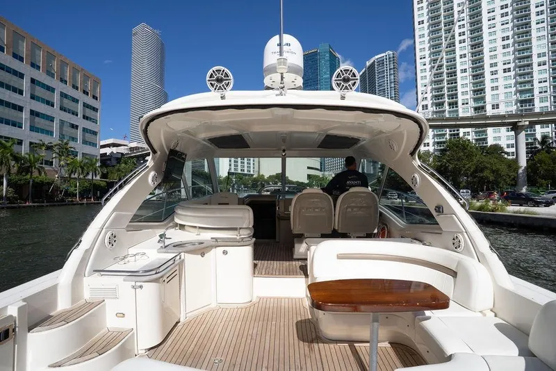 Slide: The Image of 2005 Sea Ray 48 Sundancer yacht with spacious deck, docked in urban marina. - 39