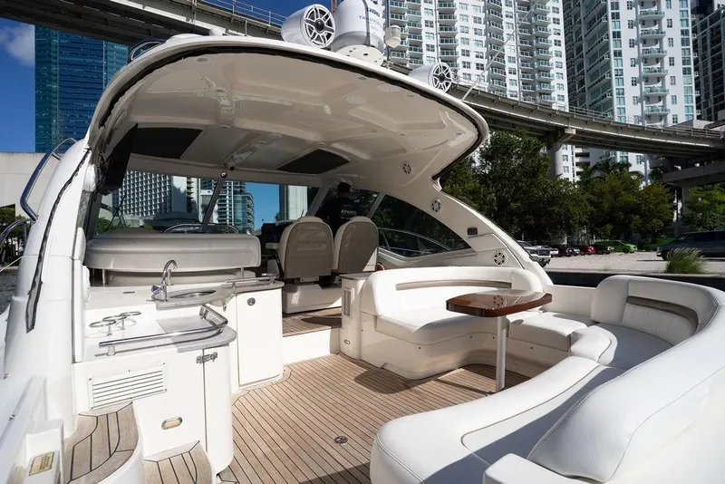 Slide: The Image of 2005 Sea Ray 48 Sundancer yacht with luxurious seating and modern amenities, docked in urban setting. - 40