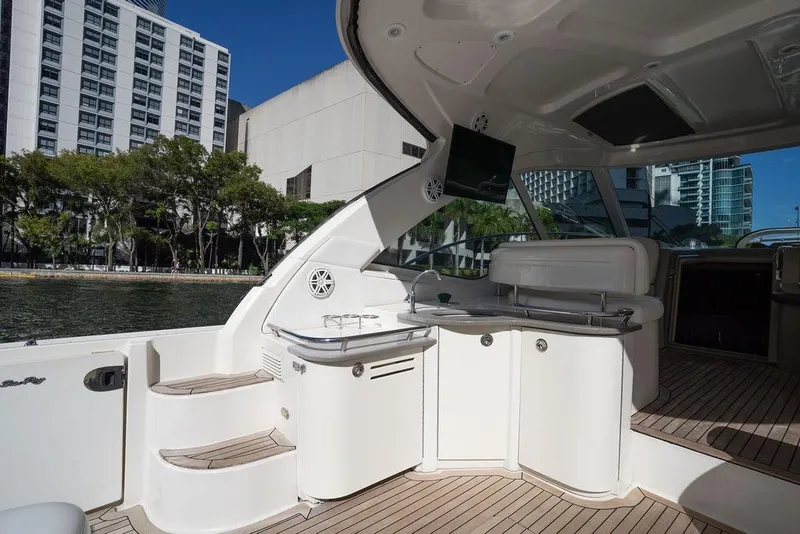 Slide: The Image of Luxurious 2005 Sea Ray 48 Sundancer yacht interior with kitchenette and cityscape view. - 41