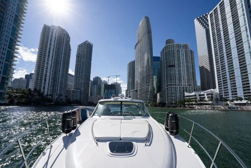 Slide: The Image of 2005 Sea Ray 48 Sundancer yacht cruising near city skyscrapers under a bright sun. - 43