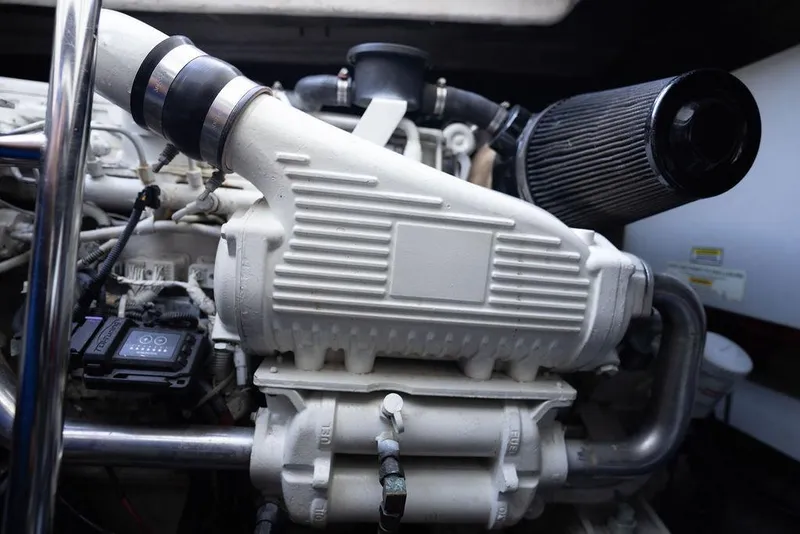 Slide: The Image of Engine compartment of a 2005 Sea Ray 48 Sundancer, showcasing mechanical components. - 49