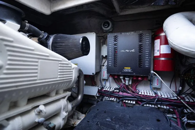 Slide: The Image of Engine room of 2005 Sea Ray 48 Sundancer with control panel and fire extinguisher. - 51