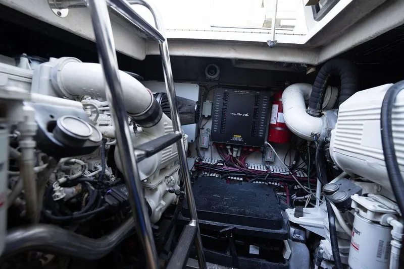 Slide: The Image of Engine room of 2005 Sea Ray 48 Sundancer yacht, featuring complex machinery and wiring. - 53