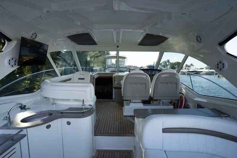 Slide: The Image of Interior of 2005 Sea Ray 48 Sundancer yacht with luxurious seating and modern amenities. - 54