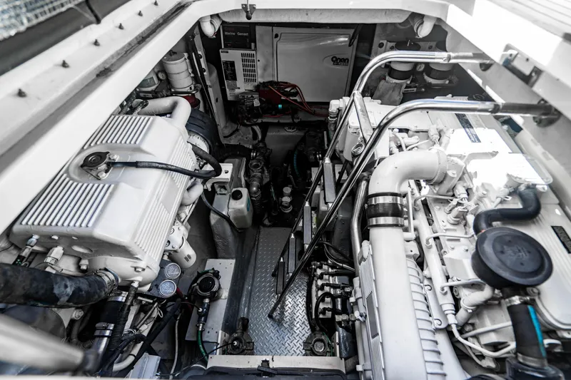 Slide: The Image of 2005 Sea Ray 48 Sundancer cruising on open water under a clear blue sky. - 7