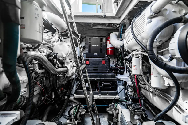 Slide: The Image of 2005 Sea Ray 48 Sundancer yacht cruising on open water with city skyline in background. - 8