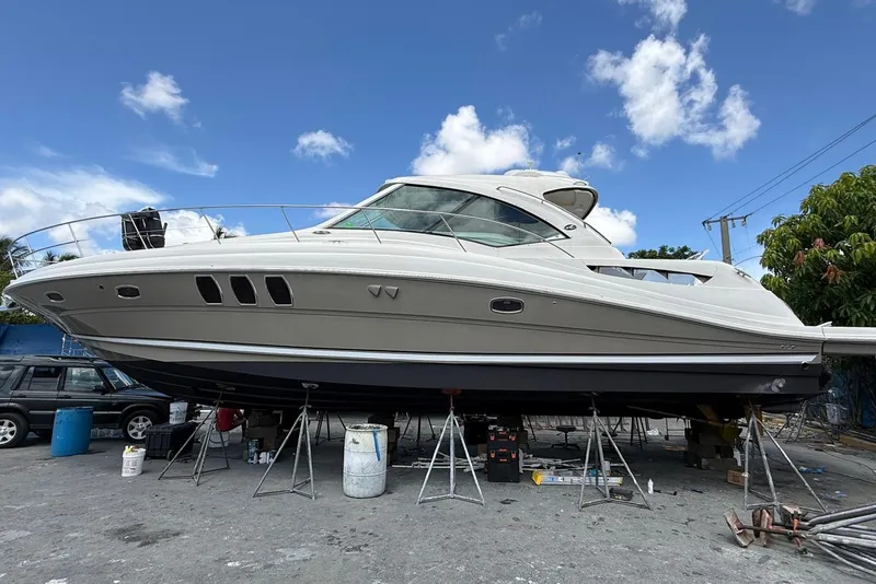 Slide: The Image of 2005 Sea Ray 48 Sundancer yacht on stands, under a clear blue sky. - 58