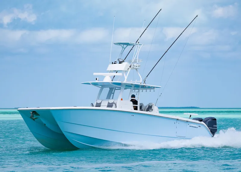 Slide: The Image of 2020 Invincible 37 Catamaran cruising on turquoise waters under a clear sky. - 4