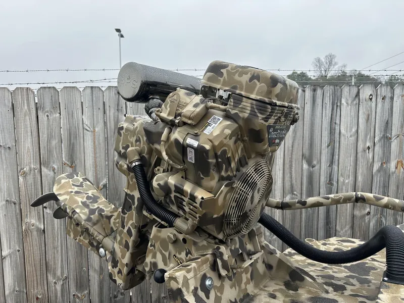 Slide: The Image of Camouflage-painted Excel Shallow Water F4 1754 F86 boat engine, 2025 model, against wooden fence. - 8