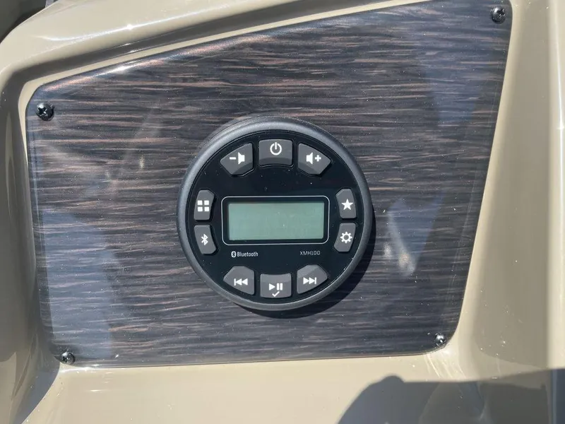 Slide: The Image of 2024 Sylvan 822 LZ Mirage boat dashboard with Bluetooth audio controls. - 11