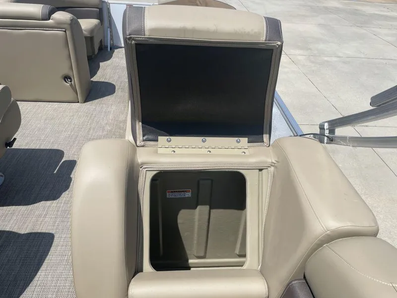 Slide: The Image of Open storage compartment on 2024 Sylvan 822 LZ Mirage boat with beige seating. - 13