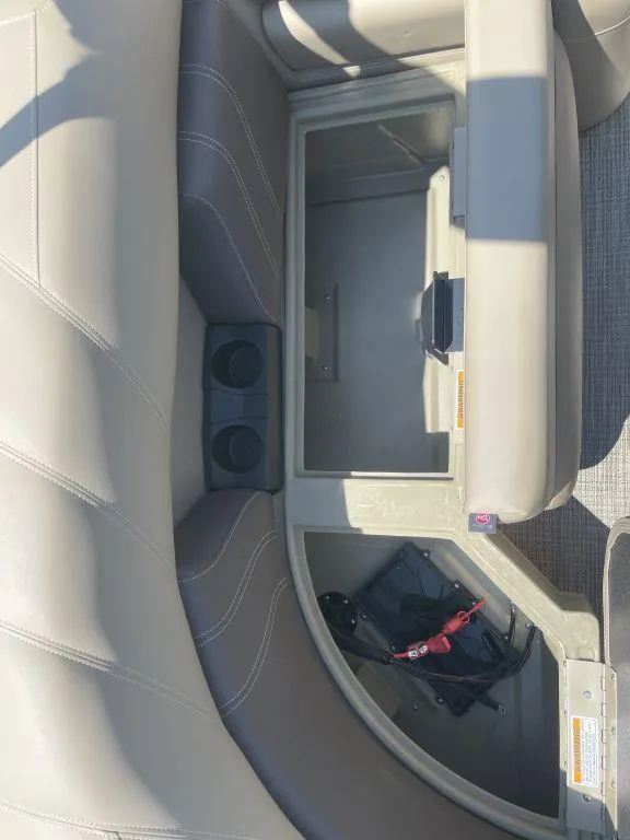 Slide: The Image of 2024 Sylvan 822 LZ Mirage boat interior storage compartment with cup holders. - 15