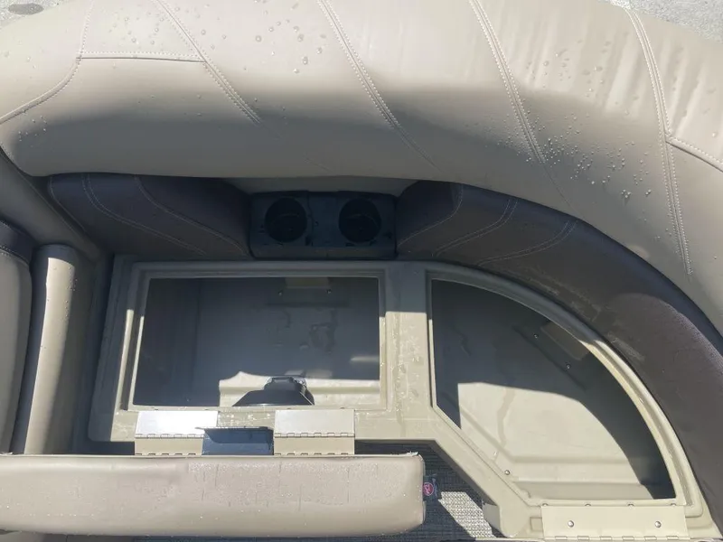 Slide: The Image of 2024 Sylvan 822 LZ Mirage boat interior with storage compartment and cup holders. - 16