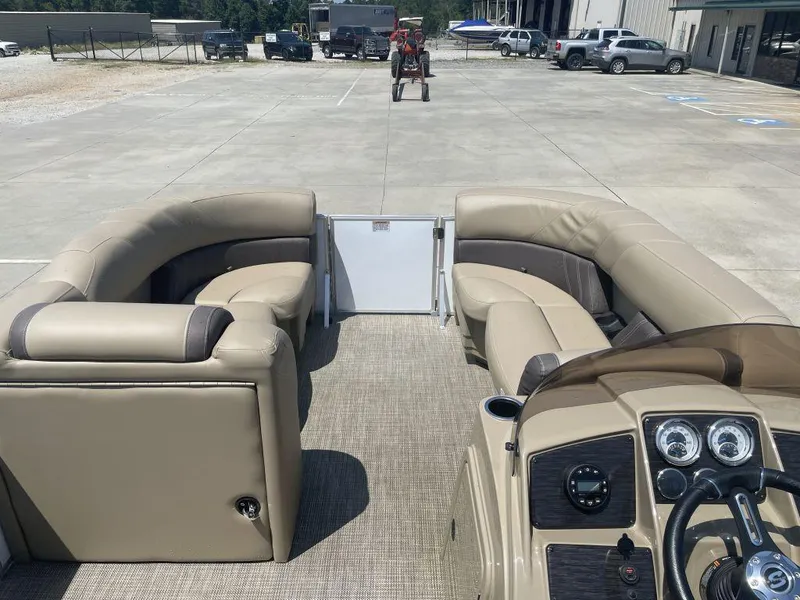 Slide: The Image of 2024 Sylvan 822 LZ Mirage pontoon boat interior with beige seating and dashboard. - 7