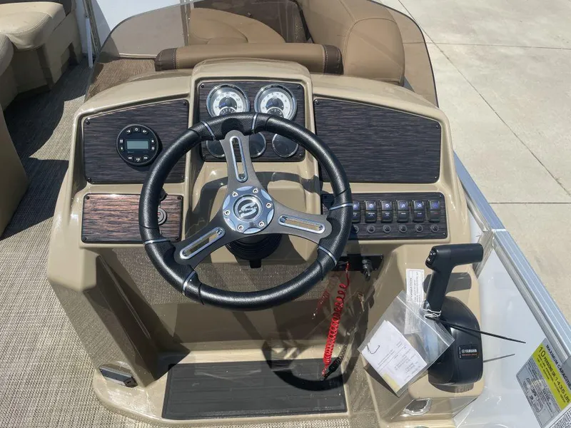 Slide: The Image of 2024 Sylvan 822 LZ Mirage boat dashboard with steering wheel and control panel. - 8