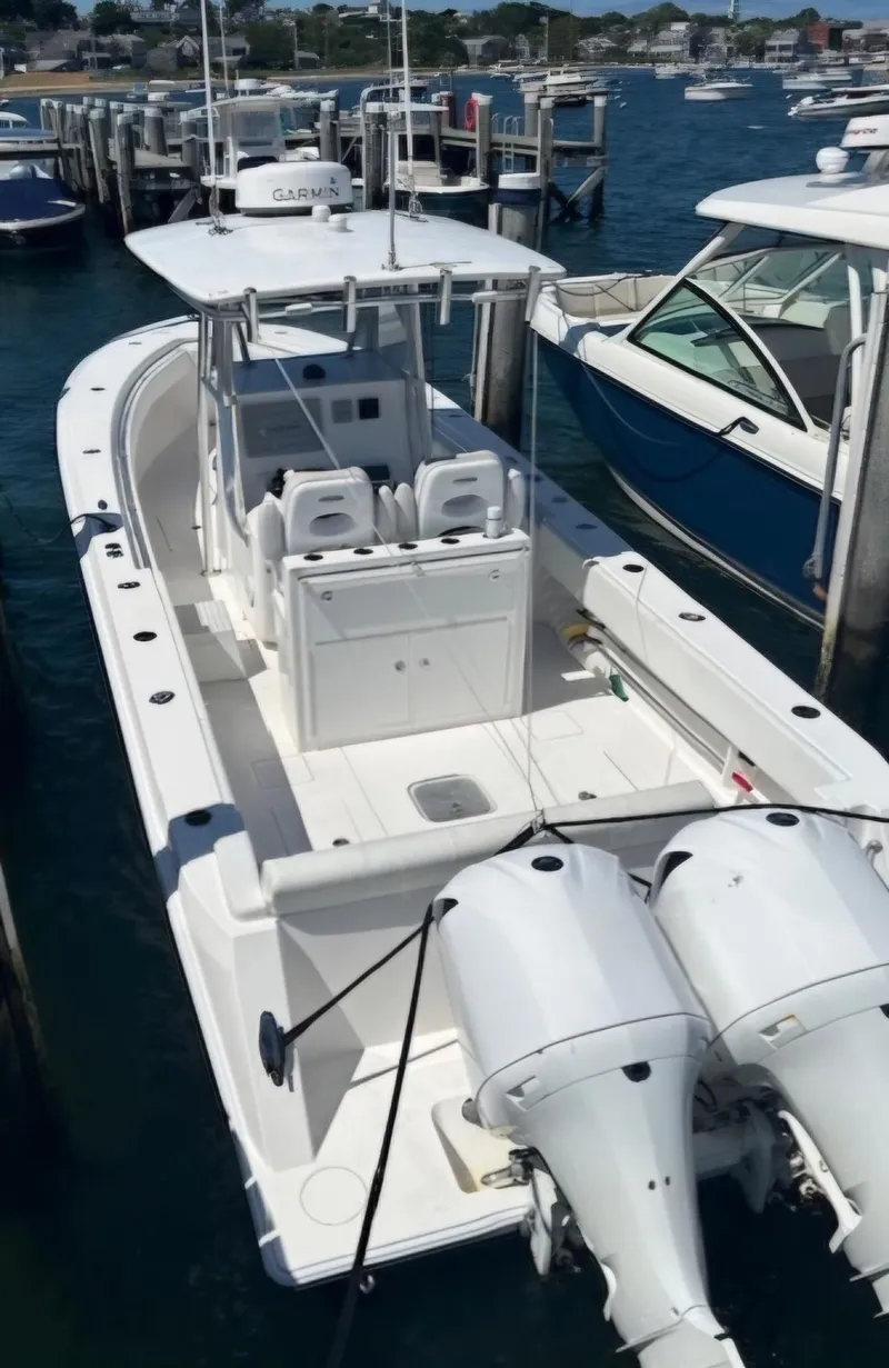 Slide: The Image of 2016 Contender 32 ST boat docked with twin engines, white exterior. - 10