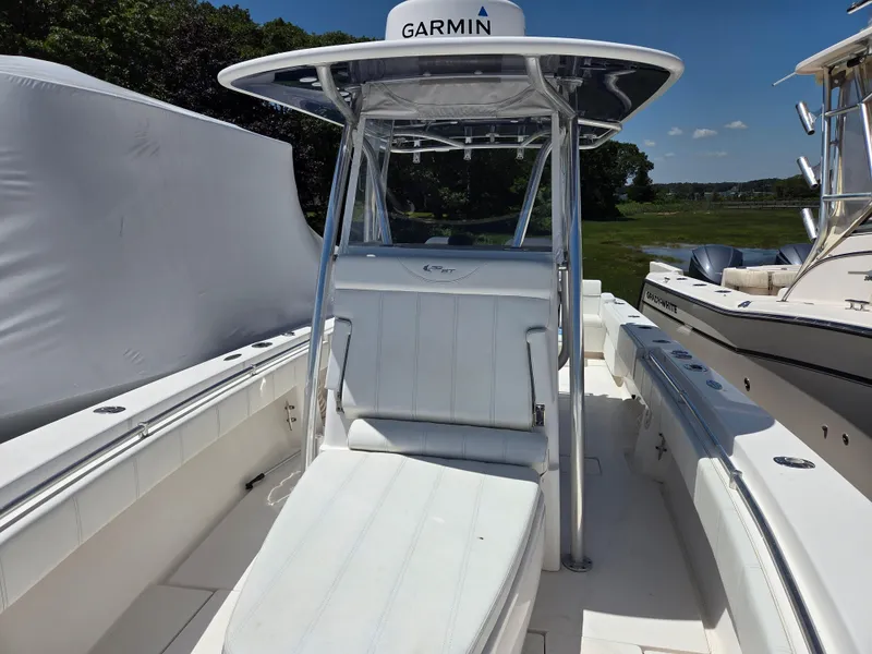Slide: The Image of 2016 Contender 32 ST boat with Garmin equipment, featuring sleek white seating and console. - 11