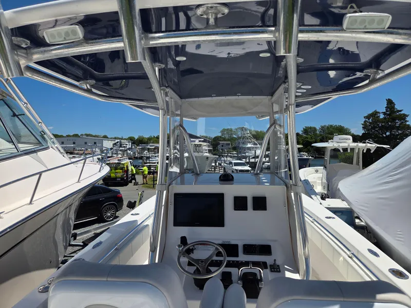Slide: The Image of 2016 Contender 32 ST boat interior with steering console and canopy, docked at marina. - 14