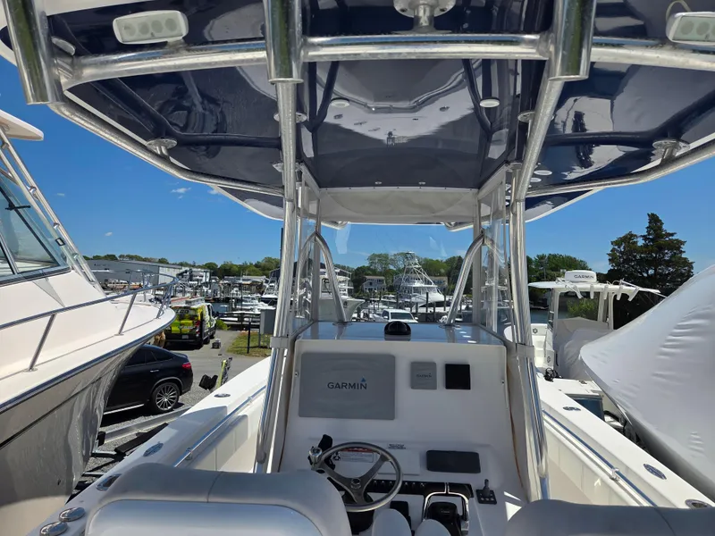 Slide: The Image of 2016 Contender 32 ST boat cockpit with Garmin navigation, docked among other vessels. - 15