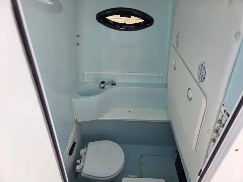 Slide: The Image of Interior of 2016 Contender 32 ST boat bathroom with sink and toilet. - 16