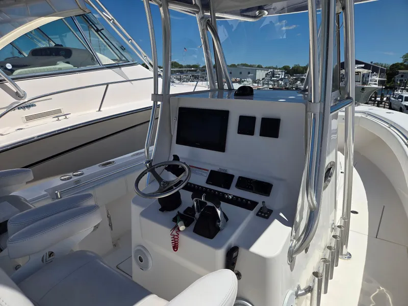 Slide: The Image of 2016 Contender 32 ST boat cockpit with steering wheel and control panel. - 18